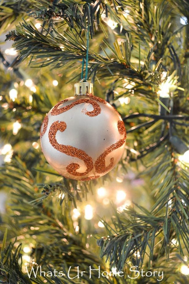 Orange Swirl Ornaments Among Pine