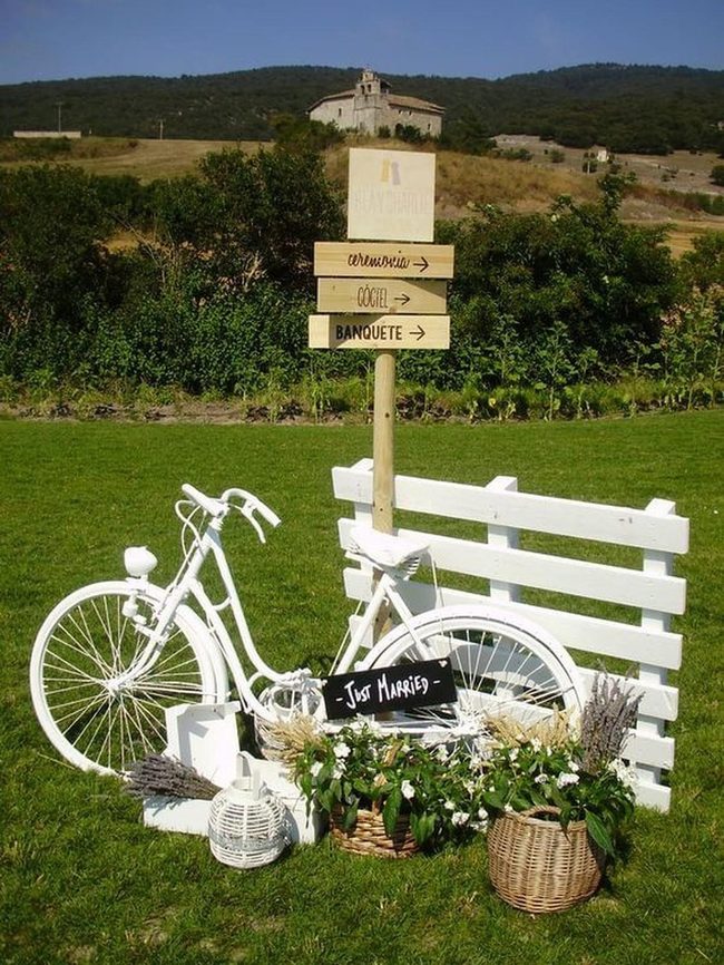 Flower-Filled Bicycles Against Weathered Wood