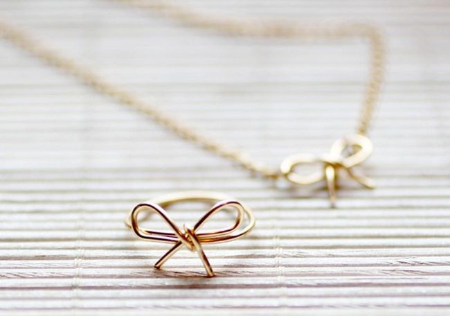 Gold Bow Necklace On Wood