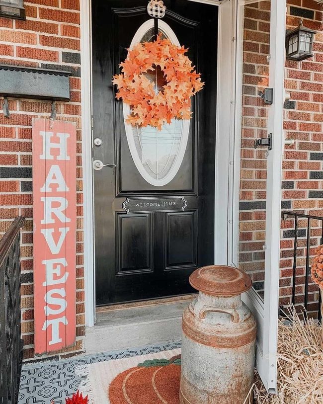 Orange Wreaths Against Black Doors