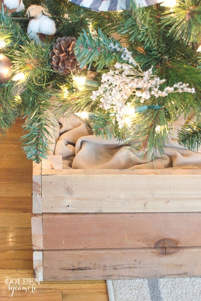 Illuminated Pine Branches Above Wooden Crates