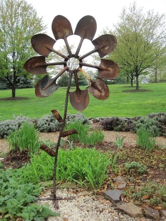 Metallic Sculptures Amid Blooming Perennials
