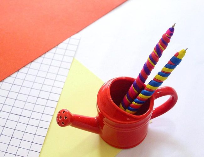 Red Watering Can With Rainbow Candles