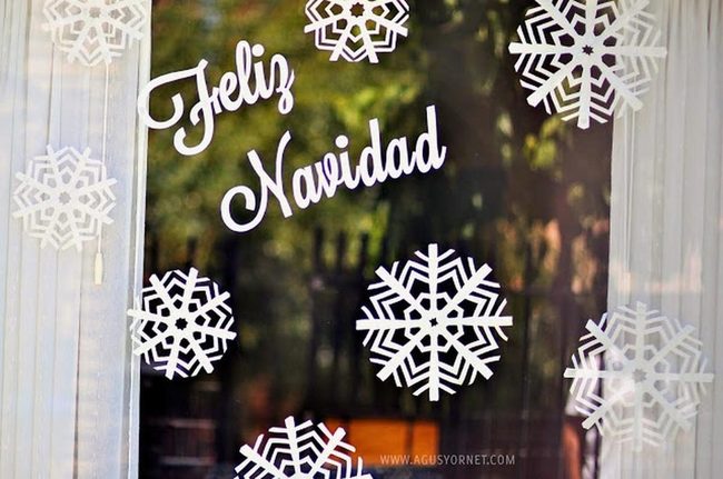White Paper Snowflakes On Glass