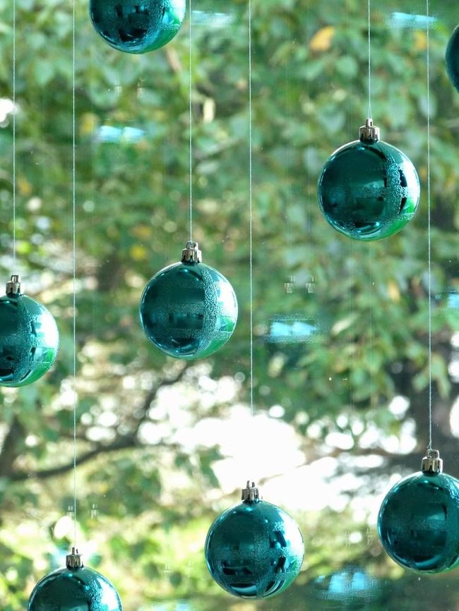 Blue-Green Glass Ornaments Catching Sunlight