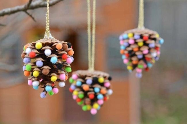 Colorful Pom-Poms On Pine Cones