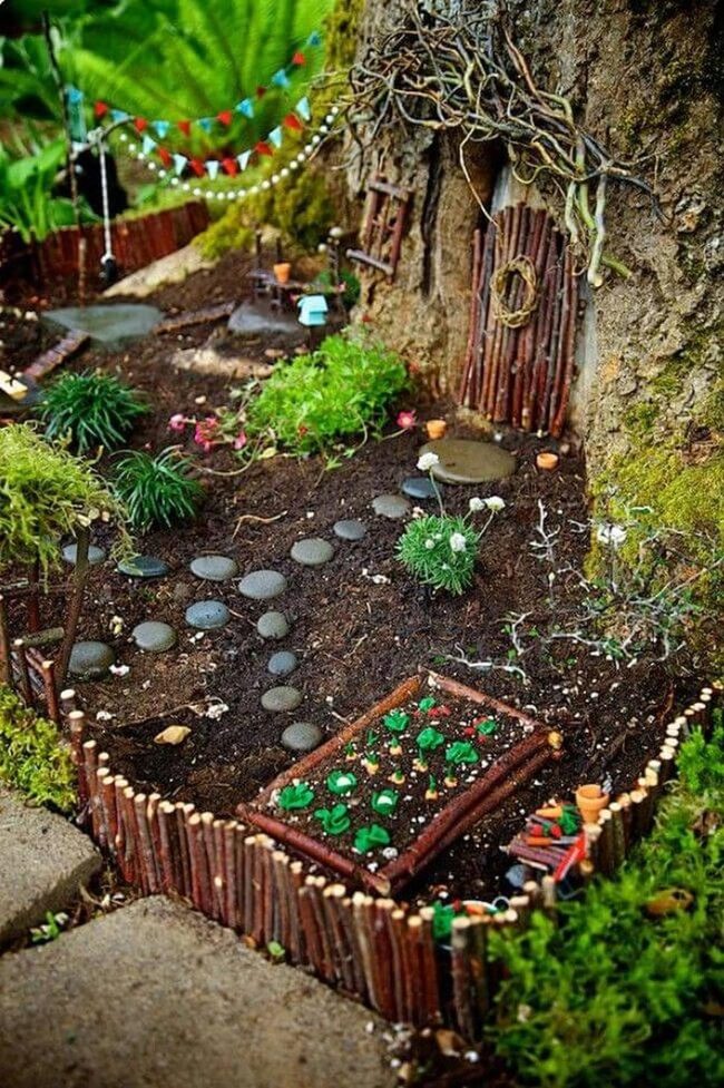 Miniature Houses Among Living Flowers