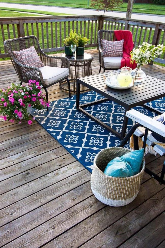 Geometric Blue Rug Anchors Wicker Seating