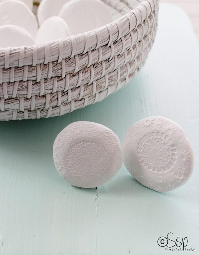 Etched Clay Discs In White Baskets