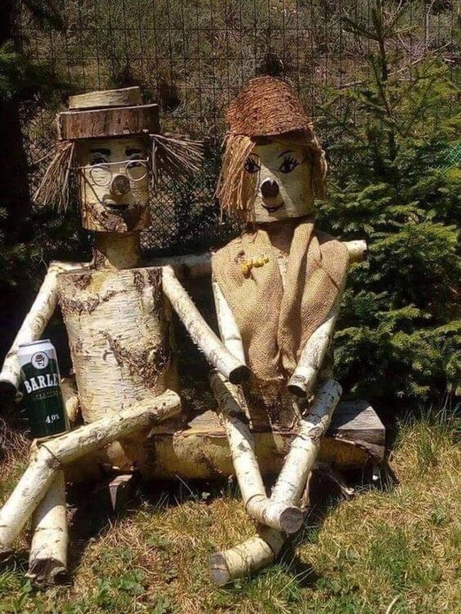 Stone Figures Among Wildflowers