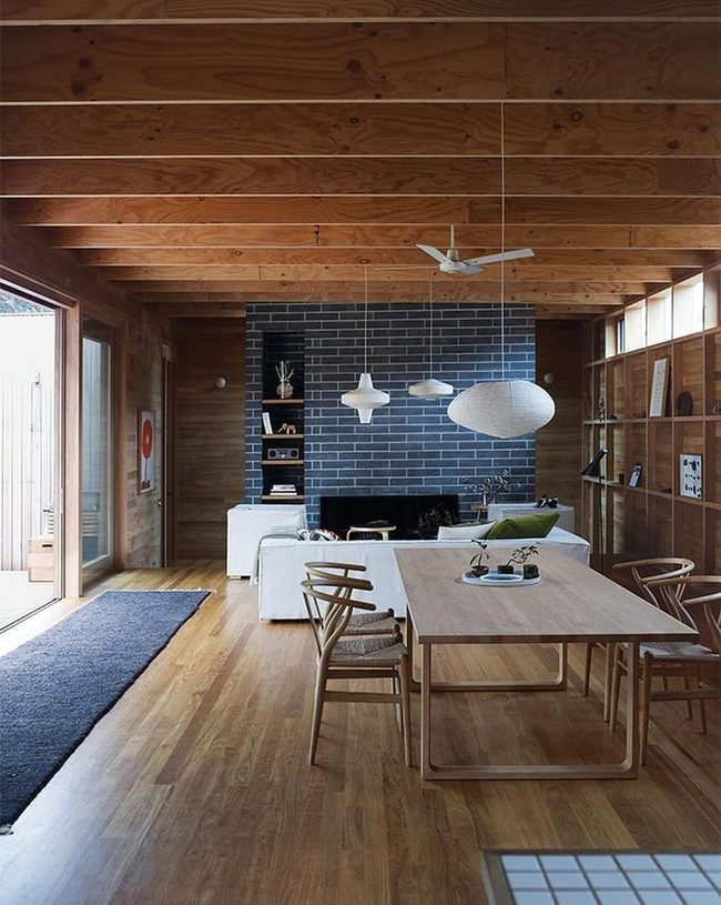 Dark Brick Fireplace Anchors Wood Warmth