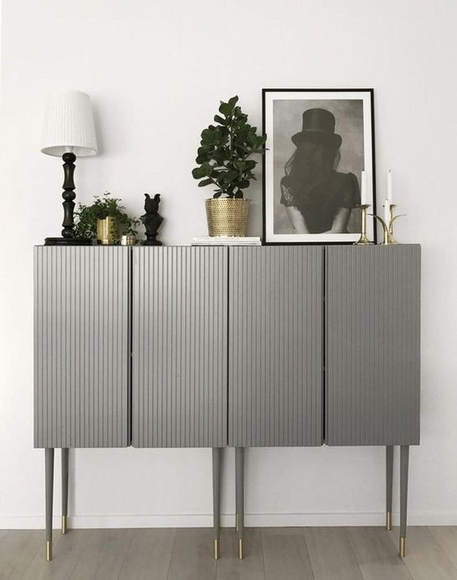 Gray Grooved Cabinets With Brass Warmth