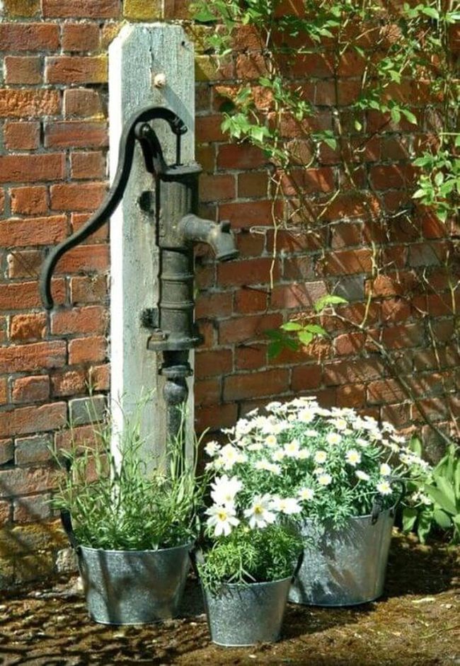 Vintage Pump Among Blooming Flowers