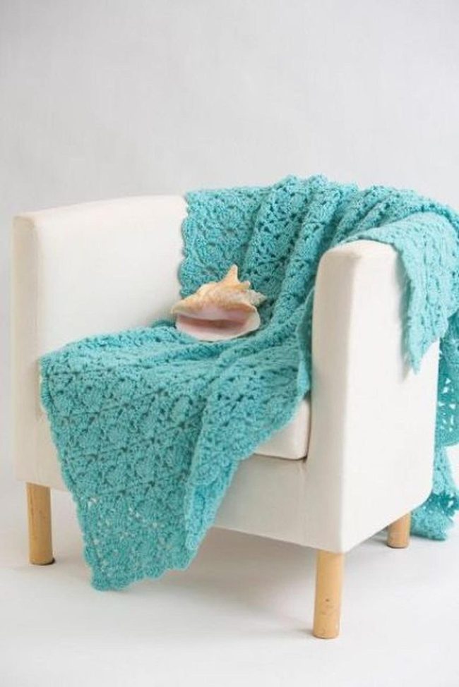 White Chair With Crochet Blanket And Seashell