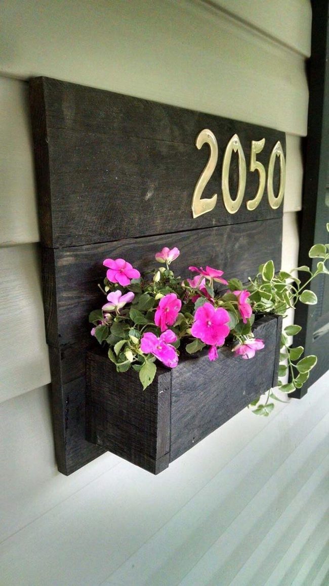 Dark Wood Pallet Numbers With Living Plants
