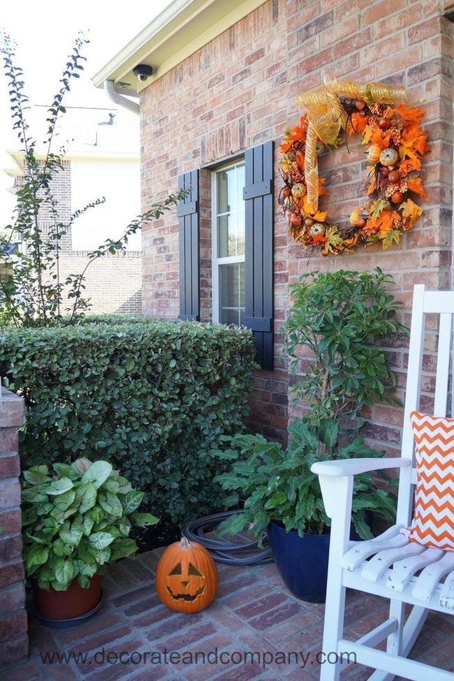 Orange Wreaths Against Black Shutters