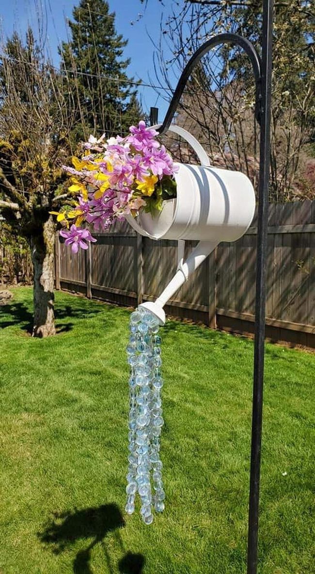Illuminated Watering Cans With Cascading Blooms