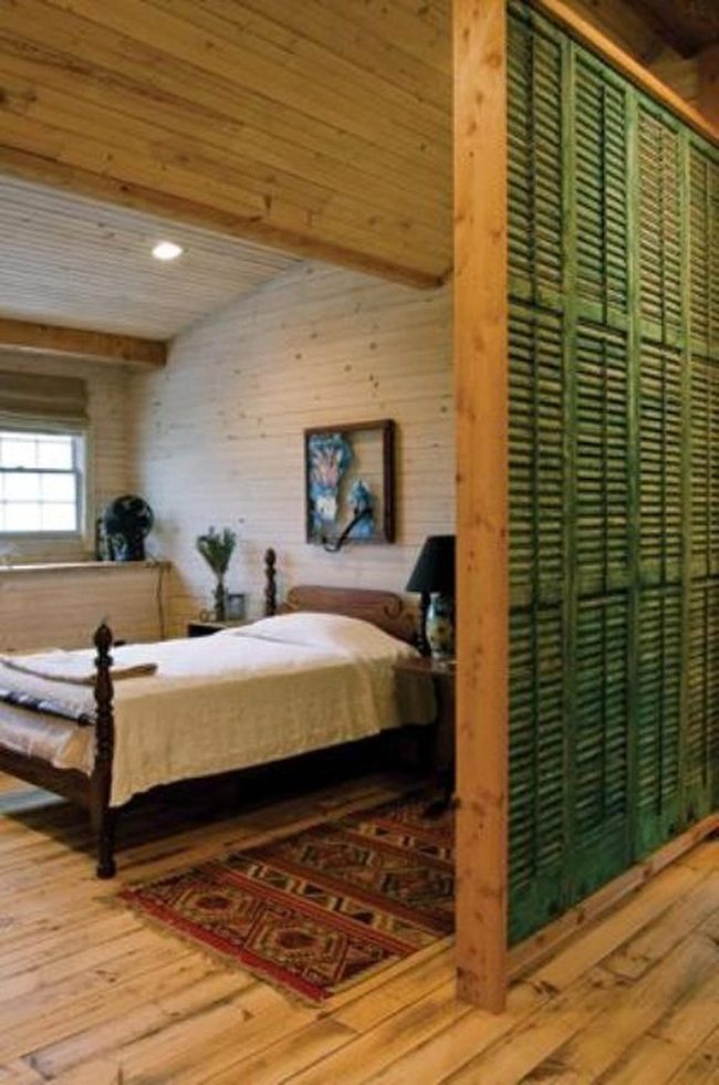 Green Shutters Against Warm Wood