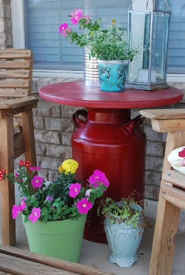 Milk Can Table Among Orange Petunias