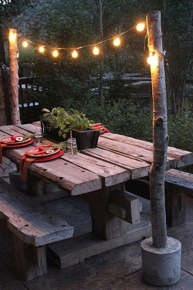 Wooden Table Under Glowing Strings