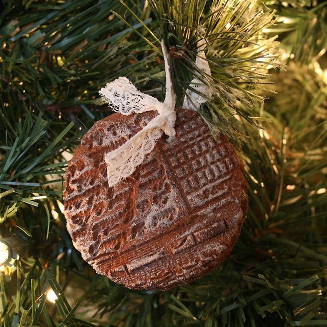 Burgundy Lace Ornament On Evergreen