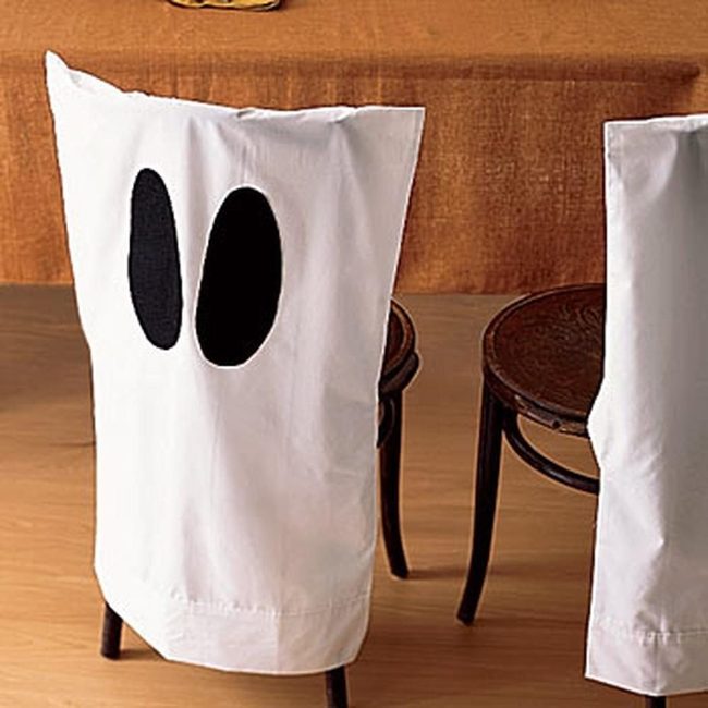 Black Oval Faces On White Chairs