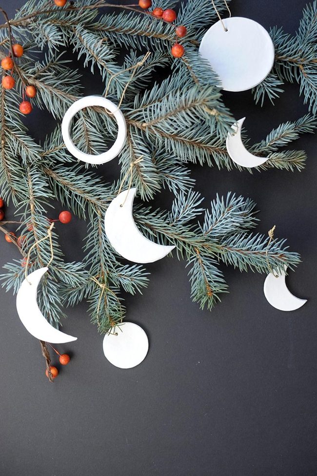 White Ceramic Ornaments Among Dark Pine