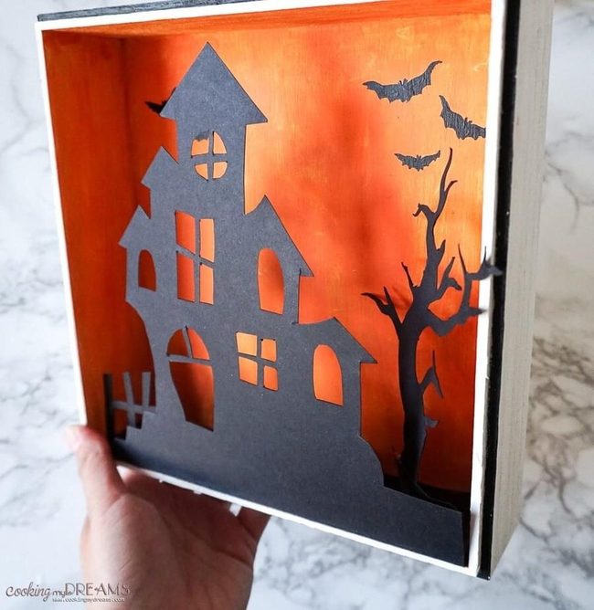 Black Silhouettes Against Glowing Orange