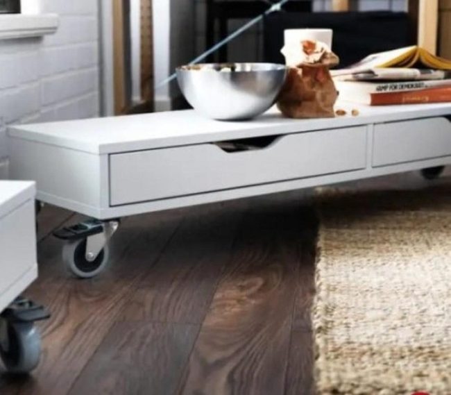 White Table With Rolling Metal Wheels