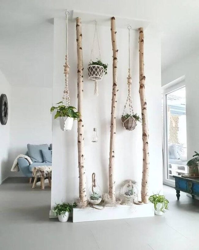Stacked Birch Logs With Hanging Plants