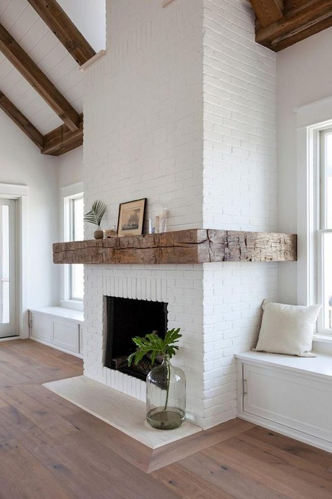White Brick Fireplace With Wood Beams