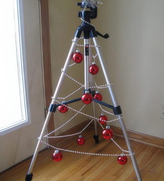 Red Ornaments On Metal Tripod