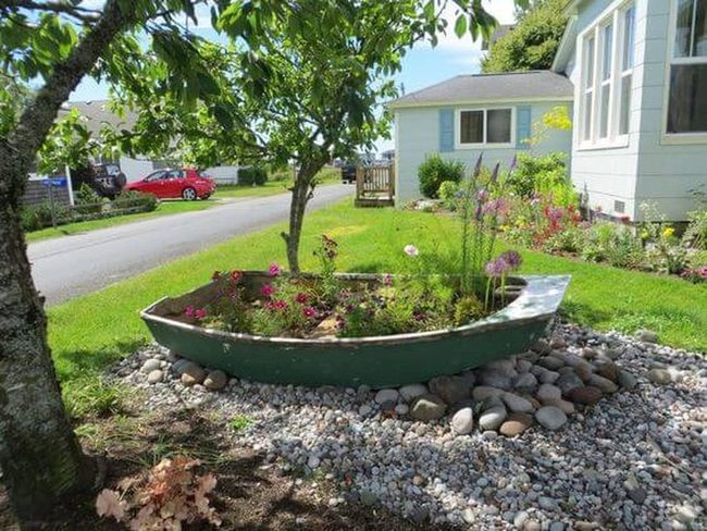 Weathered Boat Planter With Stone Frame