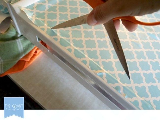 Scissors Slicing Light Blue Paper