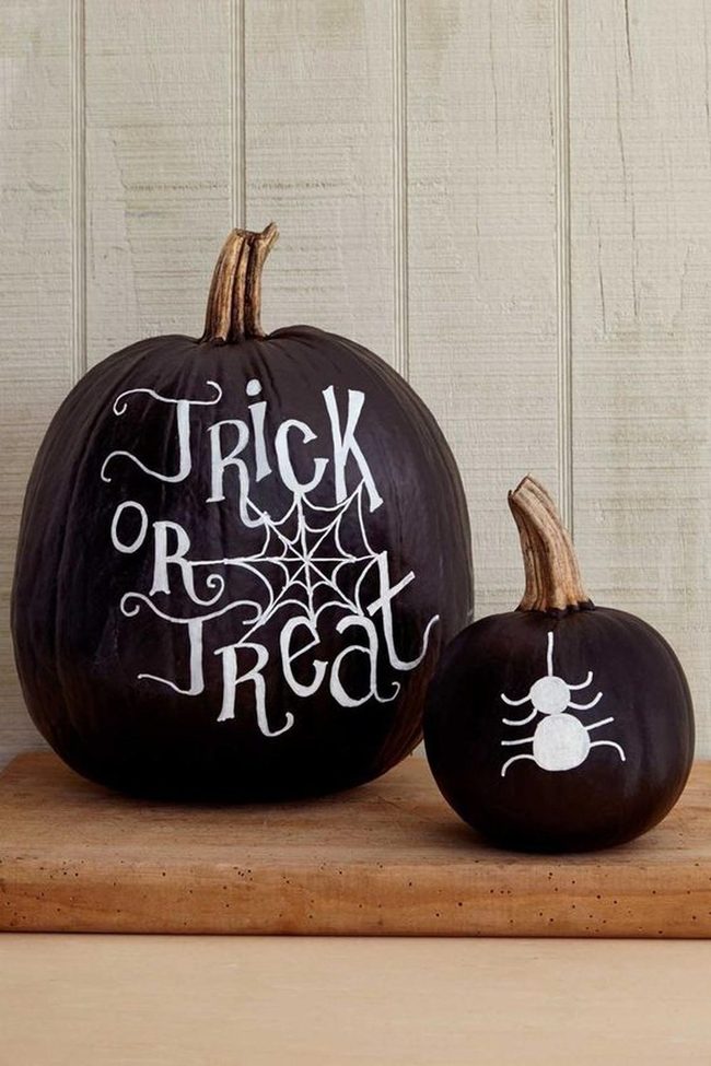 Black Painted Pumpkins With White Graphics