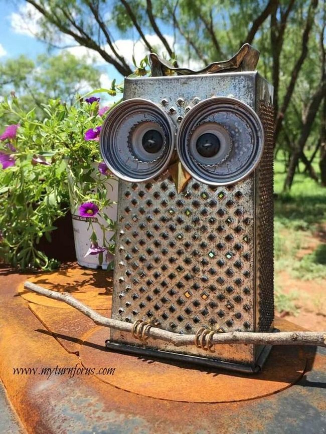 Grater Metal Owl Among Flowers