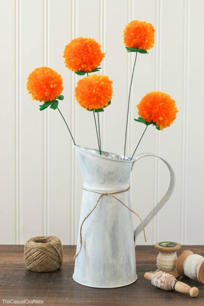 Orange Pom-Poms On Whitewashed Metal