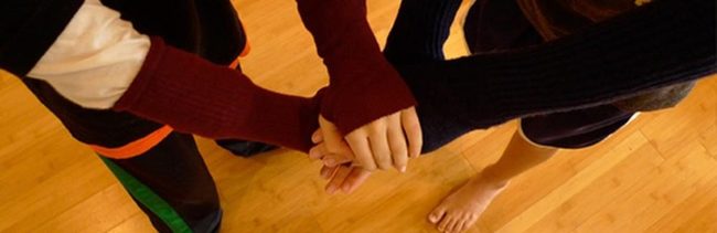 Three Hands United On Wood