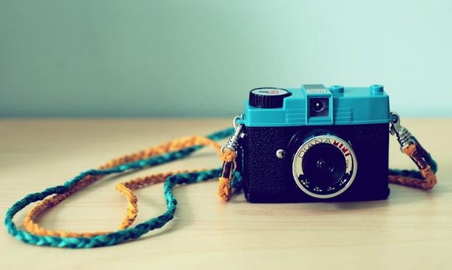 Blue Camera With Rainbow Yarn Straps
