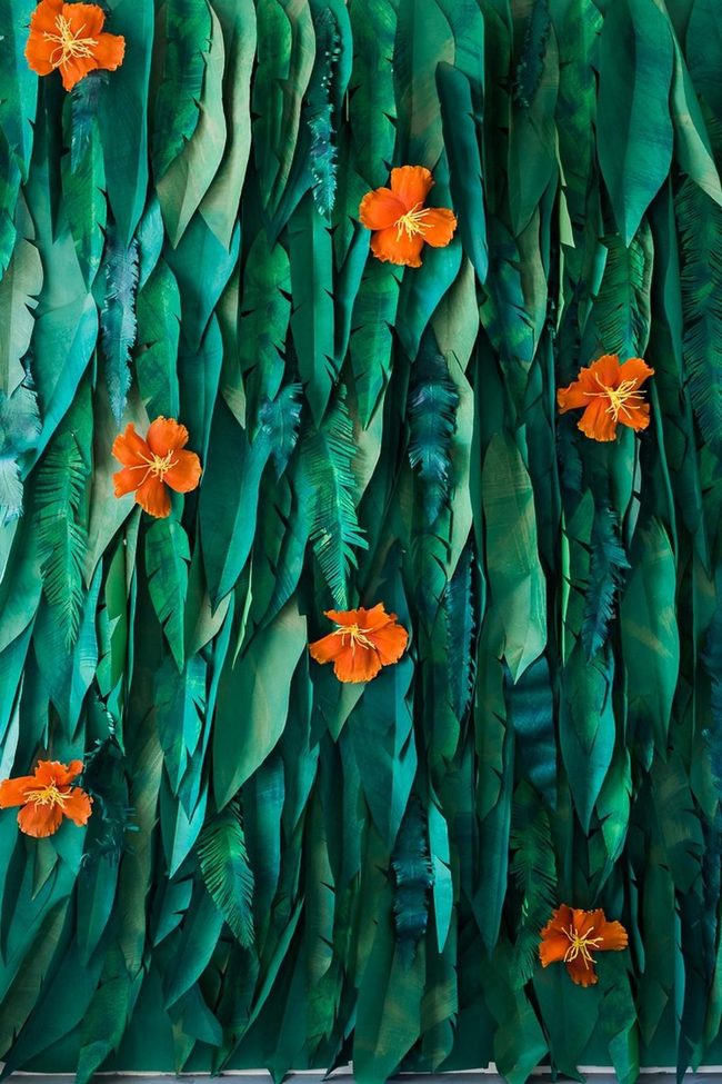 Orange Blooms Through Emerald Foliage