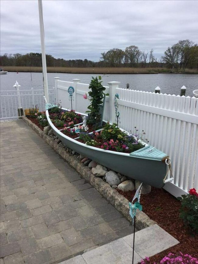 Weathered Boats Overflowing Flowers