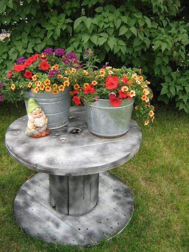 Gray Spool Table With Flower Buckets