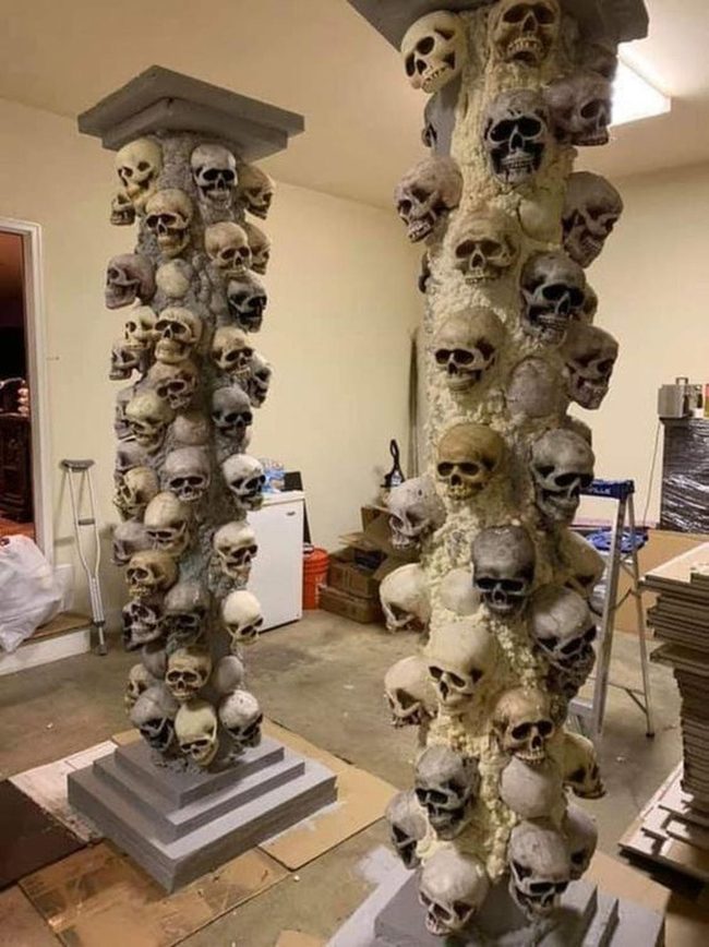 Stacked Skull Columns In Darkness